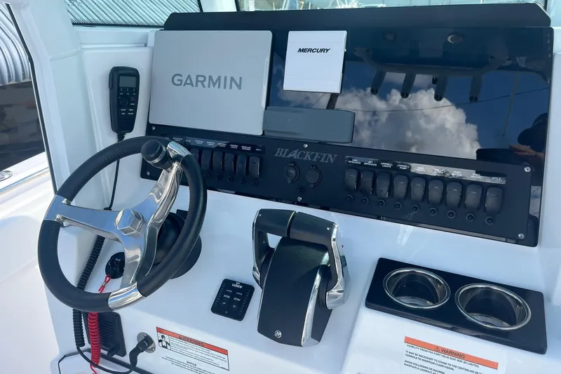  Yacht Photos Pics 2025 Blackfin 252 CC boat dashboard with Garmin and Mercury controls.