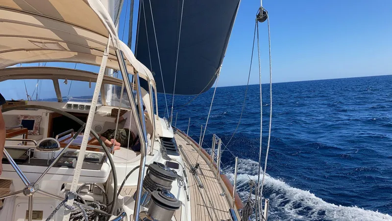 Cygnus Of Anglesey Yacht Photos Pics Sailing on a 2004 Oyster 82 yacht in open sea under clear blue skies.