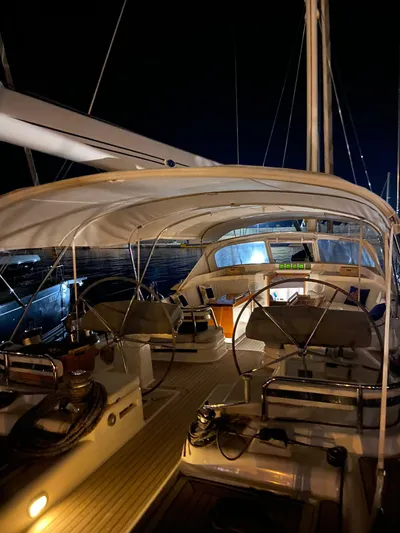 Cygnus Of Anglesey Yacht Photos Pics 2004 Oyster 82 yacht interior at night, featuring elegant seating and navigation equipment.