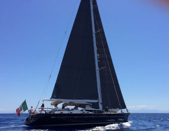 Cygnus Of Anglesey Yacht Photos Pics Sailing yacht Oyster 82, 2004 model, cruising on open sea under clear blue sky.