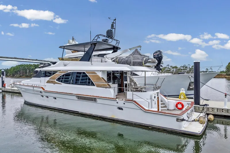  Yacht Photos Pics Luxury 2004 Queenship 76 Baretta yacht docked at marina under clear blue sky.