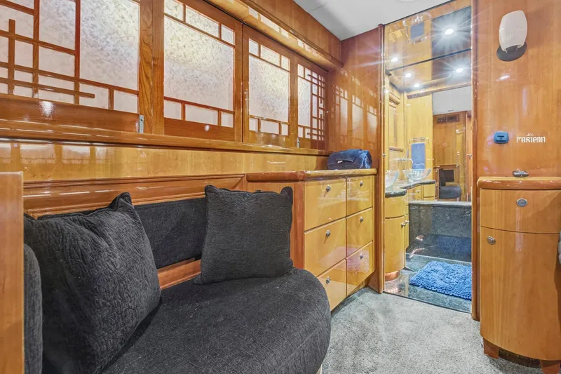  Yacht Photos Pics Luxurious interior of 2004 Queenship 76 Baretta yacht with elegant wood finishes and plush seating.