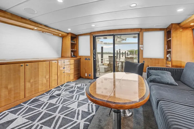  Yacht Photos Pics Luxurious interior of 2004 Queenship 76 Baretta yacht with elegant wood finishes and modern furnishings.