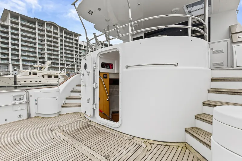  Yacht Photos Pics Luxury yacht deck of 2004 Queenship 76 Baretta, featuring elegant wood and modern design.