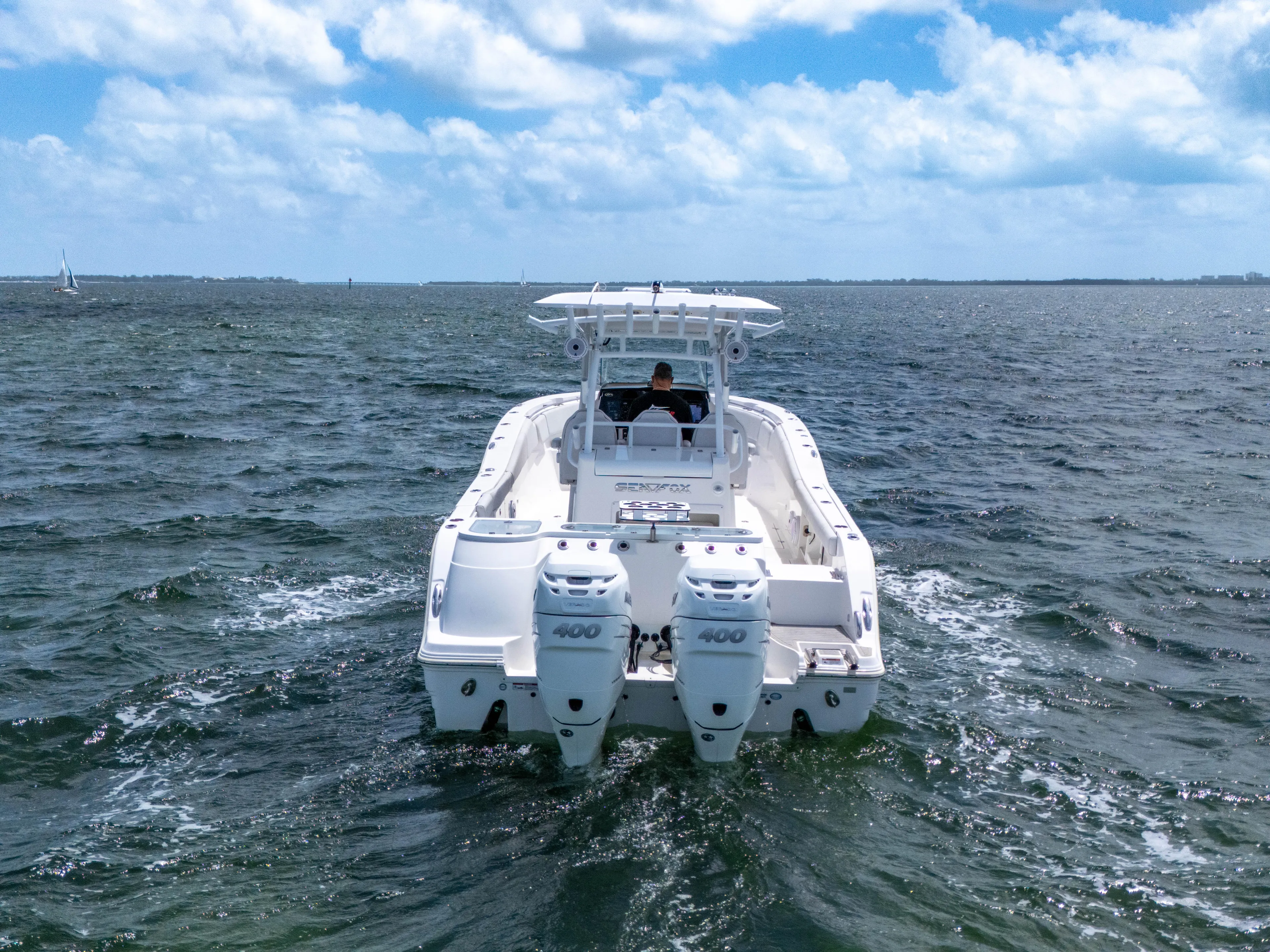  Yacht Photos Pics 2021 Sea Fox 328 Commander boat cruising on open water under a partly cloudy sky.
