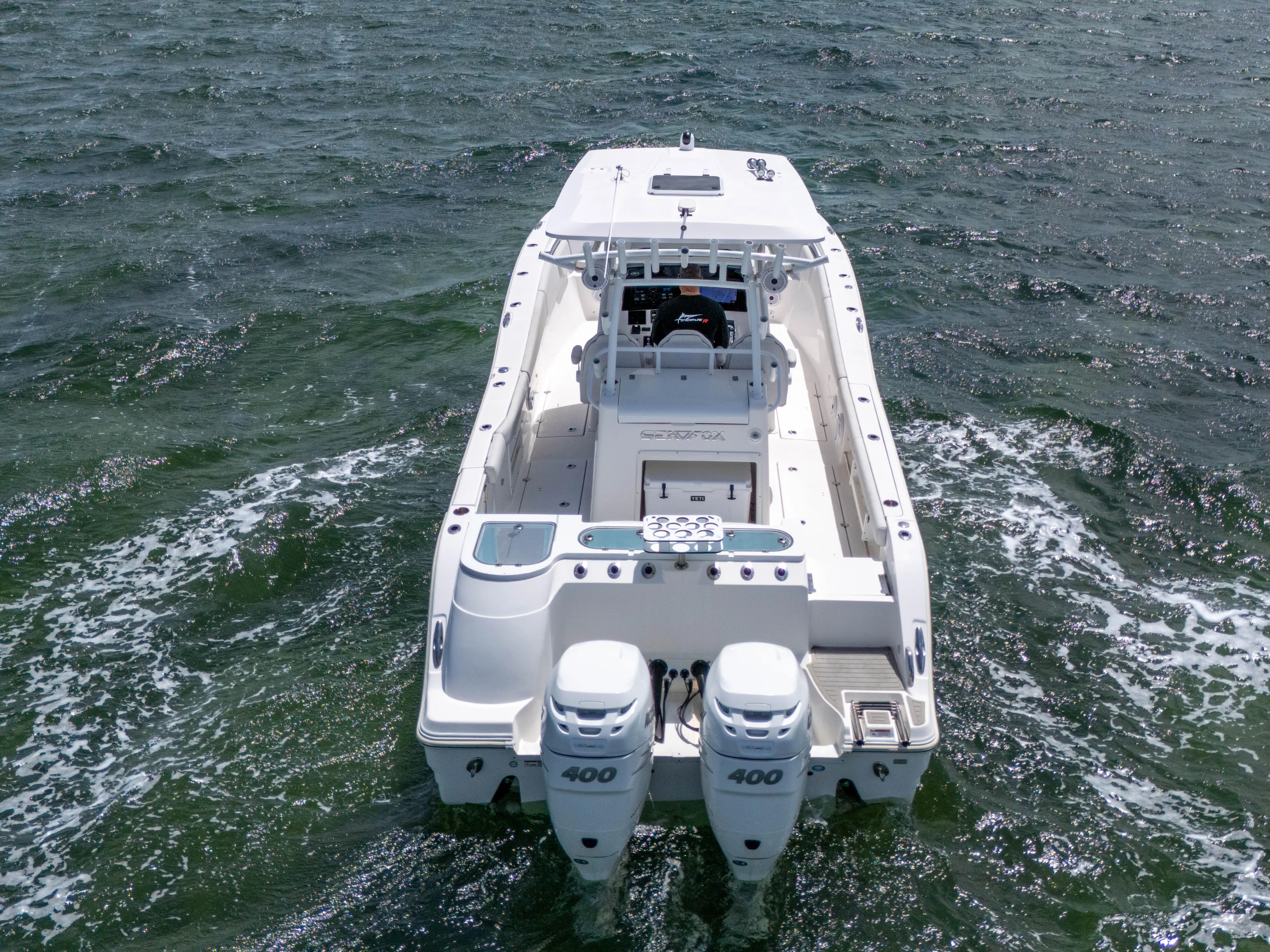  Yacht Photos Pics 2021 Sea Fox 328 Commander boat cruising on open water, rear view.