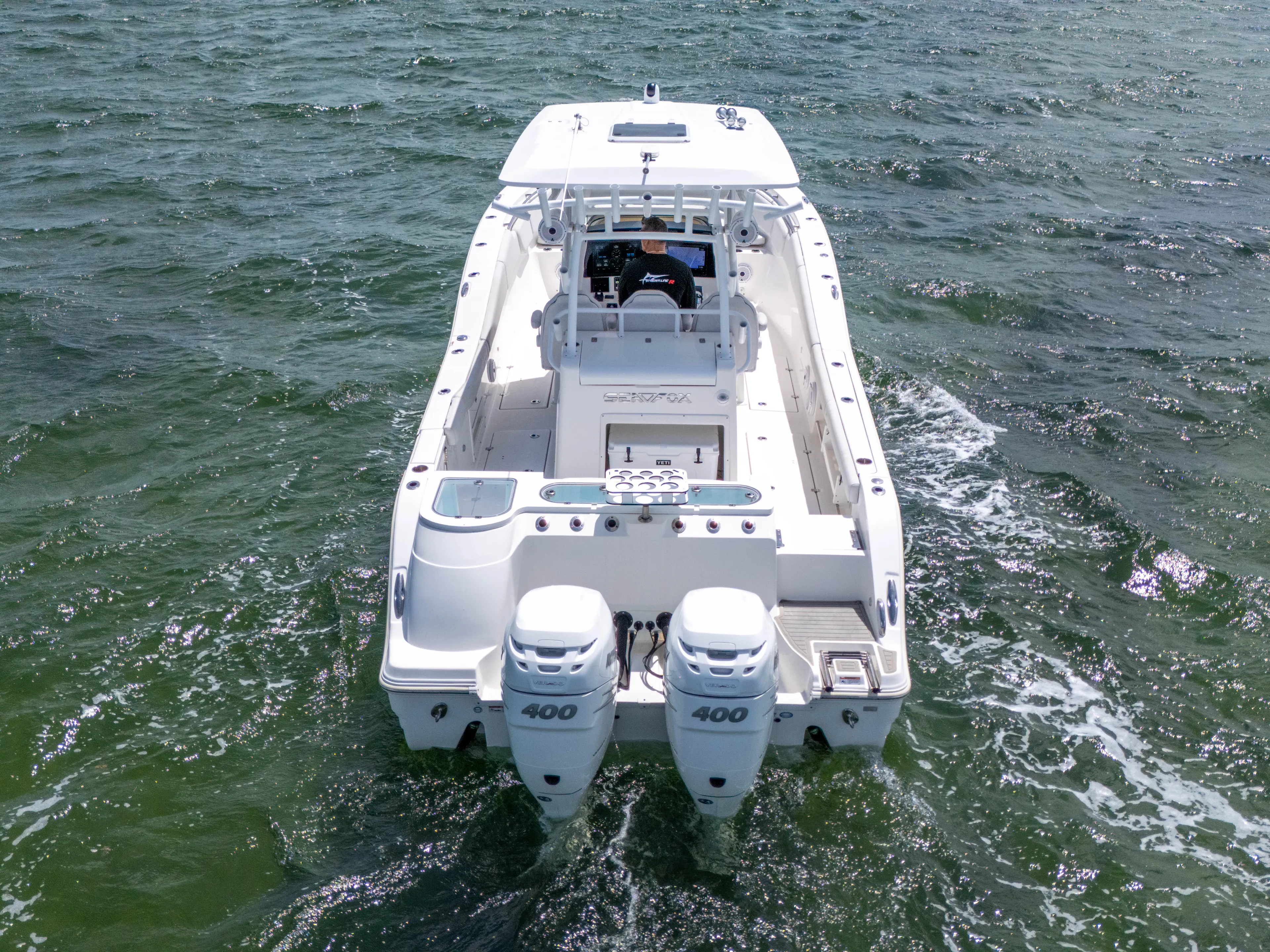  Yacht Photos Pics 2021 Sea Fox 328 Commander boat cruising on open water, rear view.