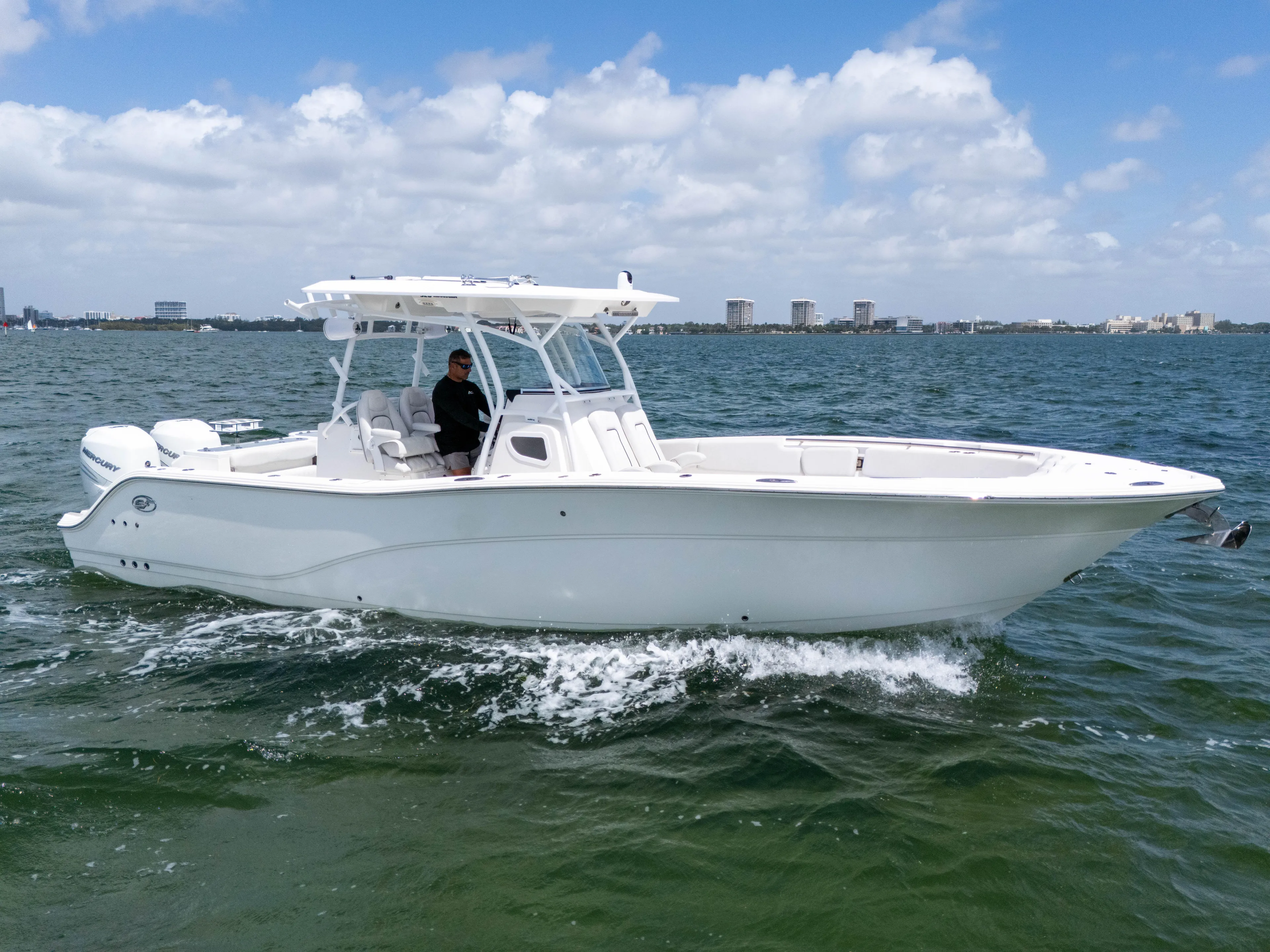  Yacht Photos Pics 2021 Sea Fox 328 Commander boat cruising on open water under a partly cloudy sky.