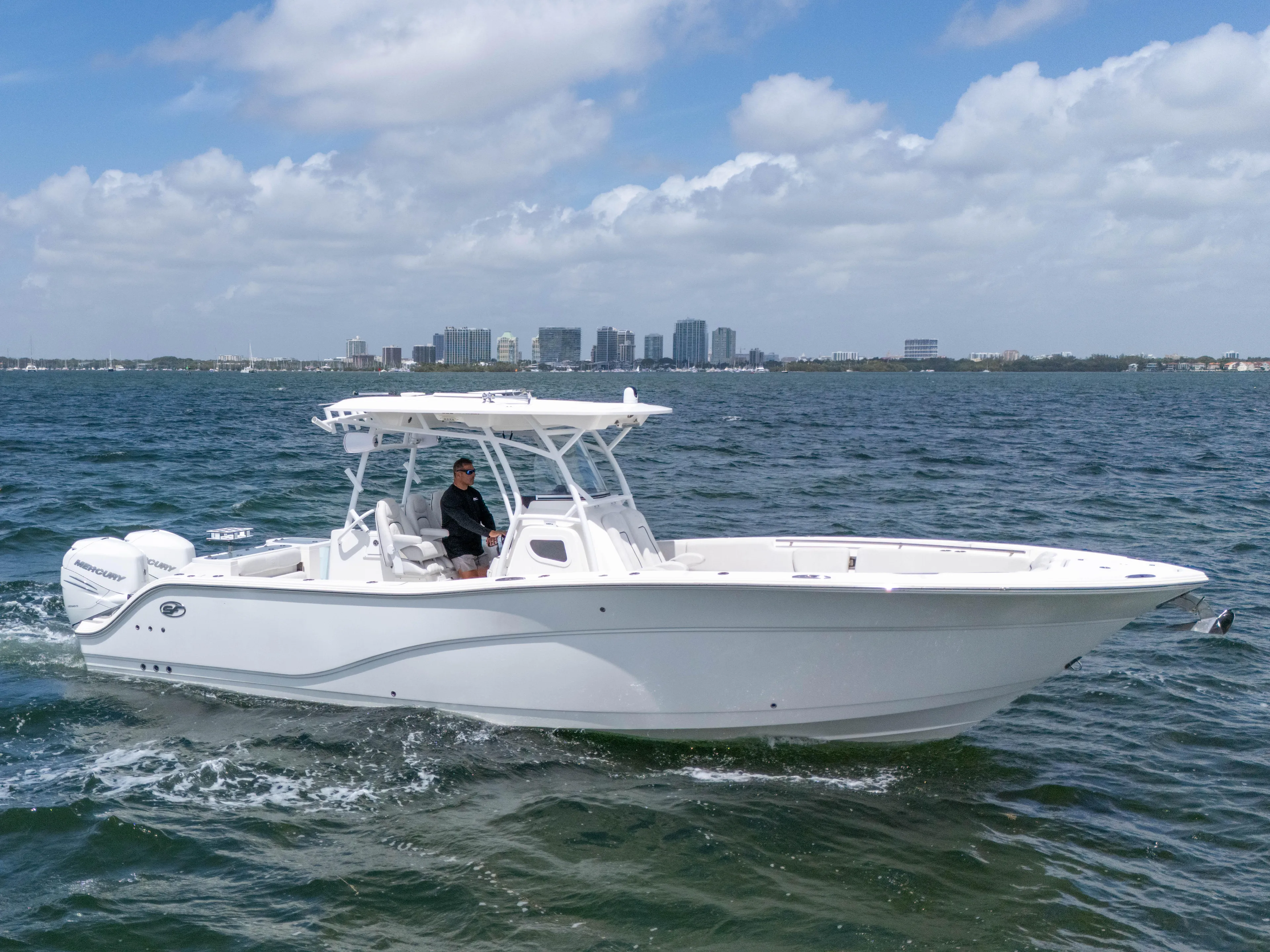 Yacht Photos Pics 2021 Sea Fox 328 Commander boat cruising on open water under a partly cloudy sky.