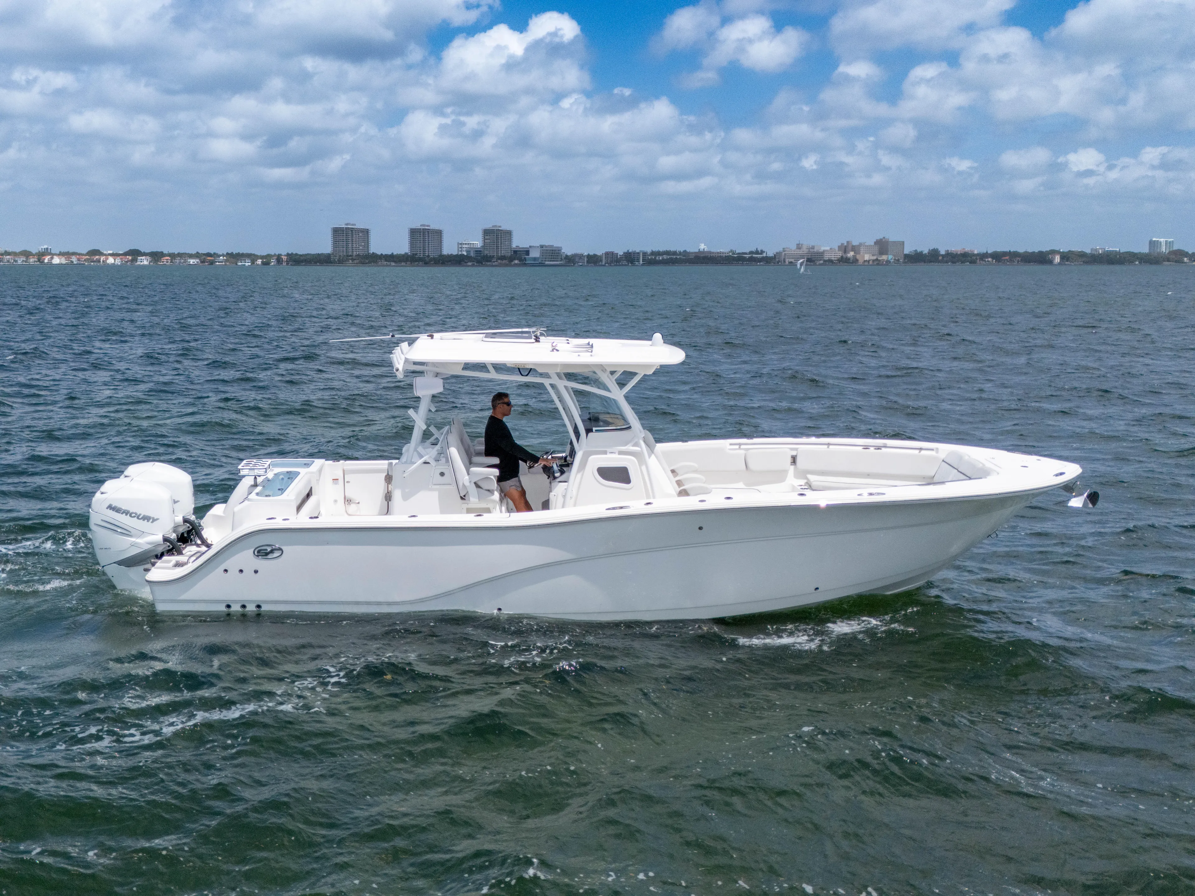  Yacht Photos Pics 2021 Sea Fox 328 Commander boat cruising on open water under a partly cloudy sky.
