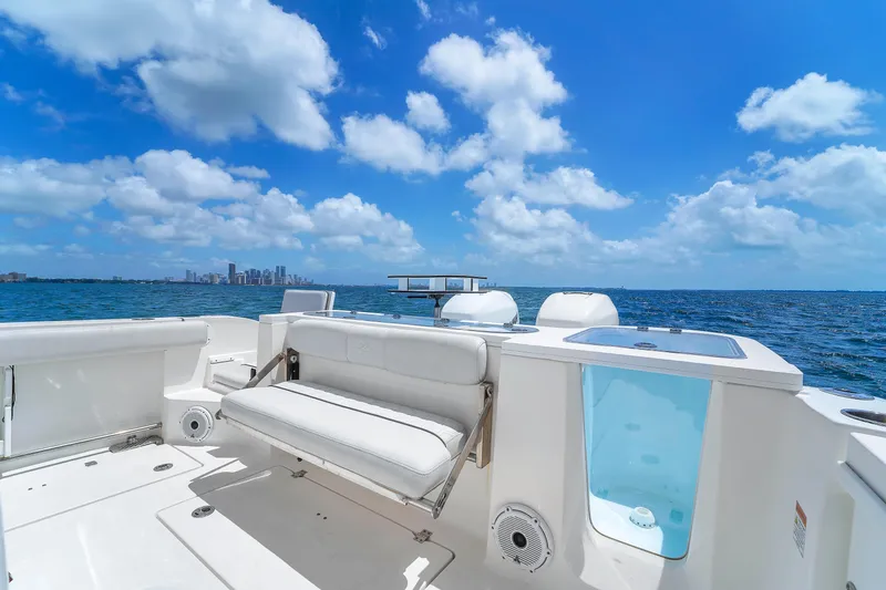  Yacht Photos Pics Sea Fox 328 Commander 2021 boat on open water, clear sky, city skyline in background.