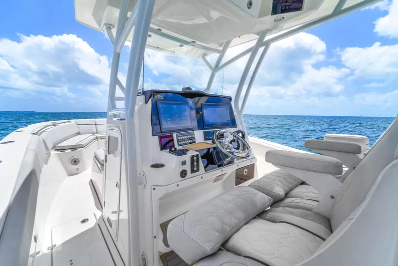  Yacht Photos Pics 2021 Sea Fox 328 Commander boat interior with modern controls, on a sunny ocean day.