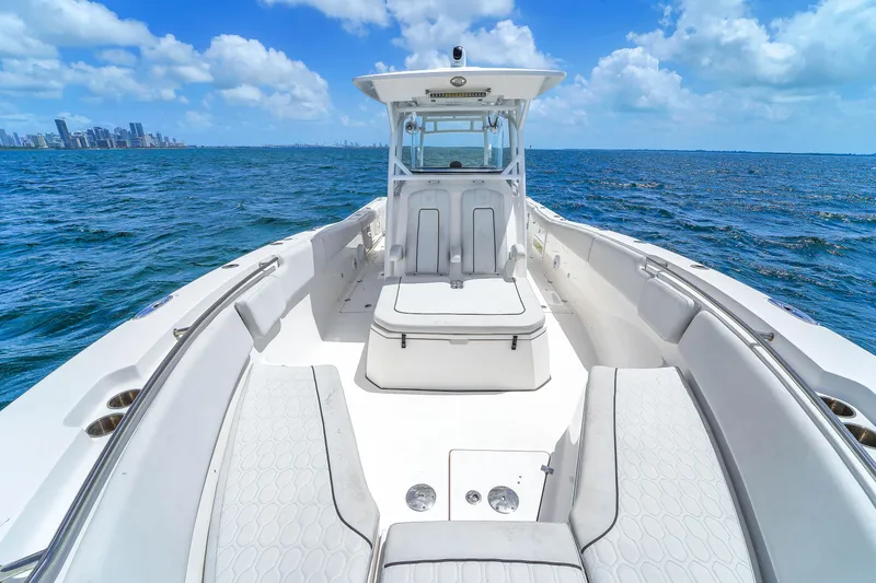  Yacht Photos Pics 2021 Sea Fox 328 Commander boat on open water with city skyline in background.
