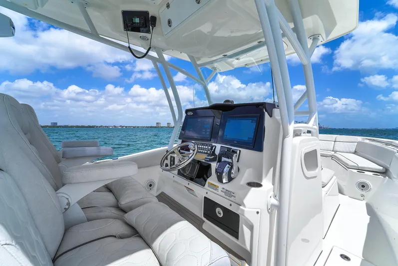 Yacht Photos Pics 2021 Sea Fox 328 Commander boat interior with modern dashboard, steering wheel, and ocean view.