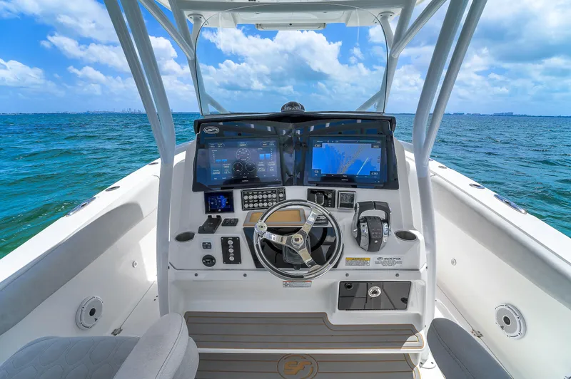  Yacht Photos Pics 2021 Sea Fox 328 Commander helm with dual displays, steering wheel, and ocean view.