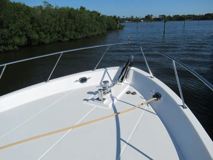 C'est La Vie Yacht Photos Pics Bow of 2010 DeFever 48 Offshore yacht on calm water near mangroves.