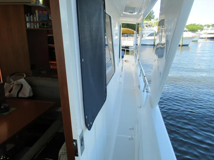 C'est La Vie Yacht Photos Pics DeFever 48 Offshore 2010 yacht side deck with marina view.