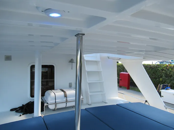 C'est La Vie Yacht Photos Pics DeFever 48 Offshore 2010 yacht interior with blue seating and white ladder.