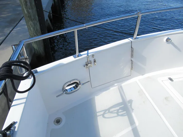 C'est La Vie Yacht Photos Pics DeFever 48 Offshore 2010 boat deck with stainless steel railing and water view.