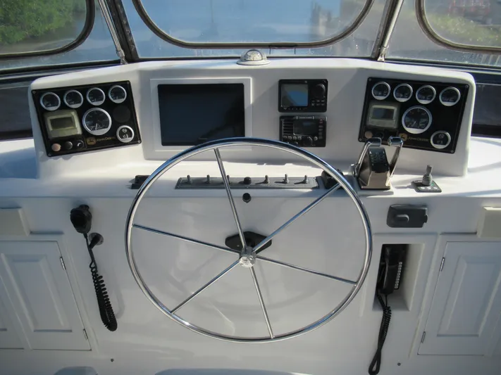 C'est La Vie Yacht Photos Pics DeFever 48 Offshore 2010 yacht helm with navigation instruments and steering wheel.
