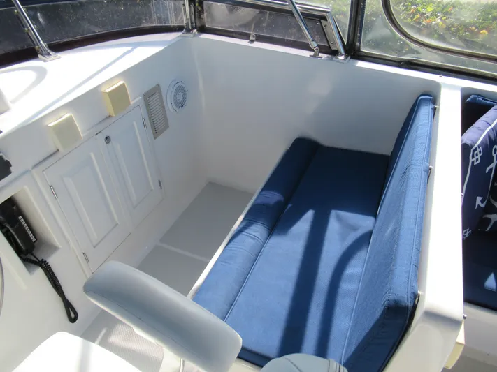 C'est La Vie Yacht Photos Pics Interior seating area of 2010 DeFever 48 Offshore yacht with blue cushions.