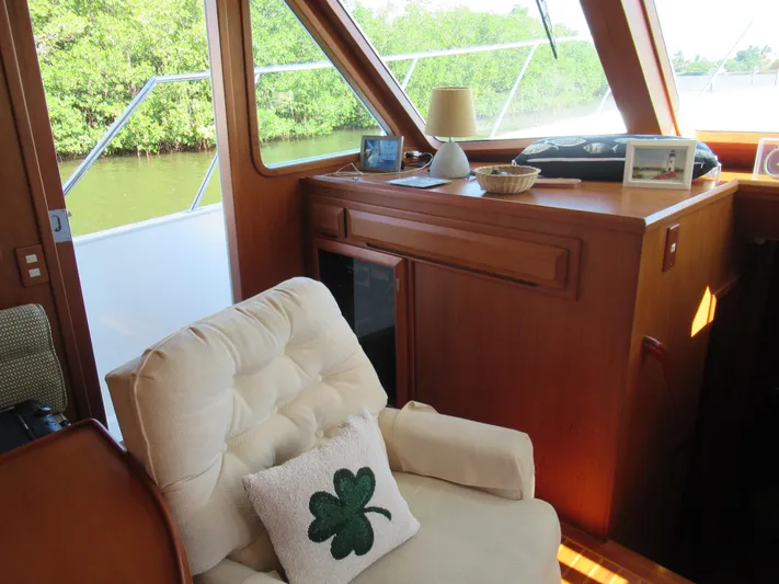 C'est La Vie Yacht Photos Pics Cozy interior of 2010 DeFever 48 Offshore yacht with armchair and shamrock pillow.