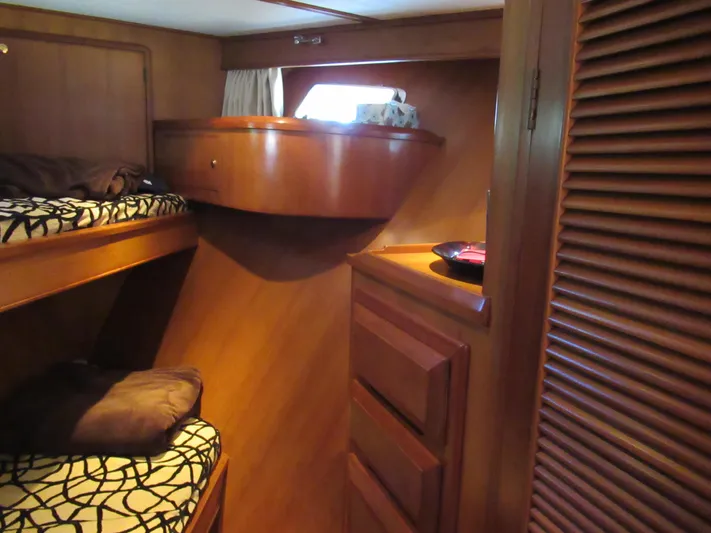 C'est La Vie Yacht Photos Pics 2010 DeFever 48 Offshore cabin with wooden bunk beds and storage.
