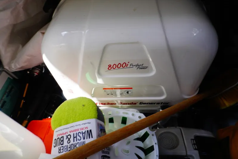 Boondoggle Yacht Photos Pics Fischer Panda 8000i generator in Beneteau Antares 11, 2022 model, with cleaning supplies nearby.