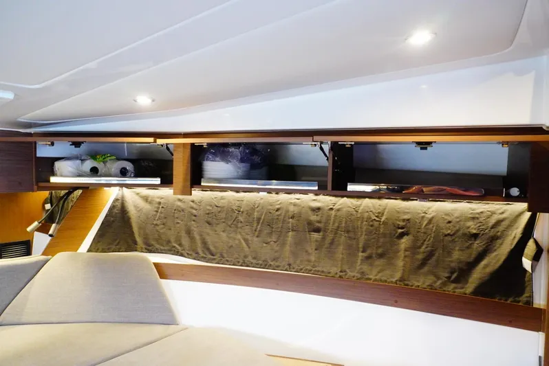Boondoggle Yacht Photos Pics Interior of 2022 Beneteau Antares 11, featuring modern lighting and sleek storage design.