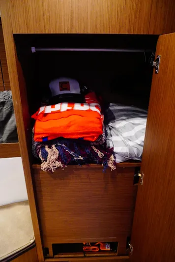 Boondoggle Yacht Photos Pics Wooden closet in 2022 Beneteau Antares 11, storing clothes and accessories.