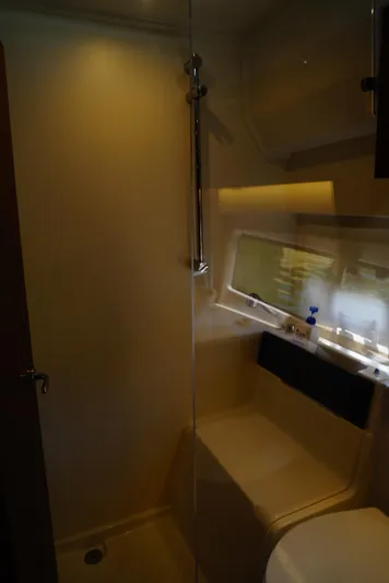 Boondoggle Yacht Photos Pics Bathroom interior of 2022 Beneteau Antares 11 boat, featuring modern fixtures and lighting.