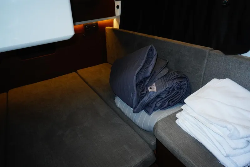 Boondoggle Yacht Photos Pics Interior cabin of 2022 Beneteau Antares 11 with folded bedding and towels.