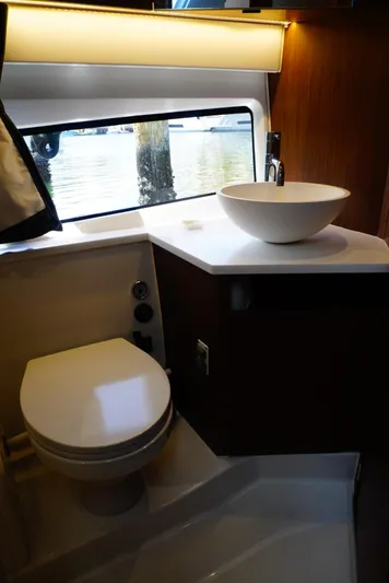 Boondoggle Yacht Photos Pics 2022 Beneteau Antares 11 bathroom with modern fixtures and window view.