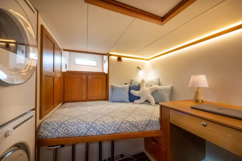 Yacht Photos Pics Luxurious cabin interior of 2027 Sabre 51 Salon Express with cozy bed and modern amenities.