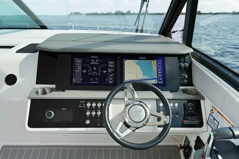 Liquid Asset Yacht Photos Pics 2022 Sea Ray Sundancer 320 helm with modern navigation displays and steering wheel.