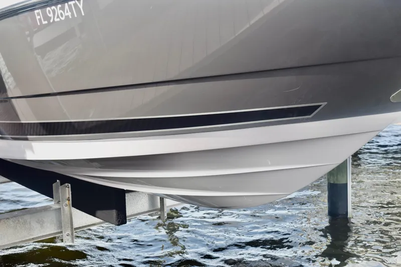  Yacht Photos Pics 2025 Monterey 275SS Super Sport boat hull on lift above water.