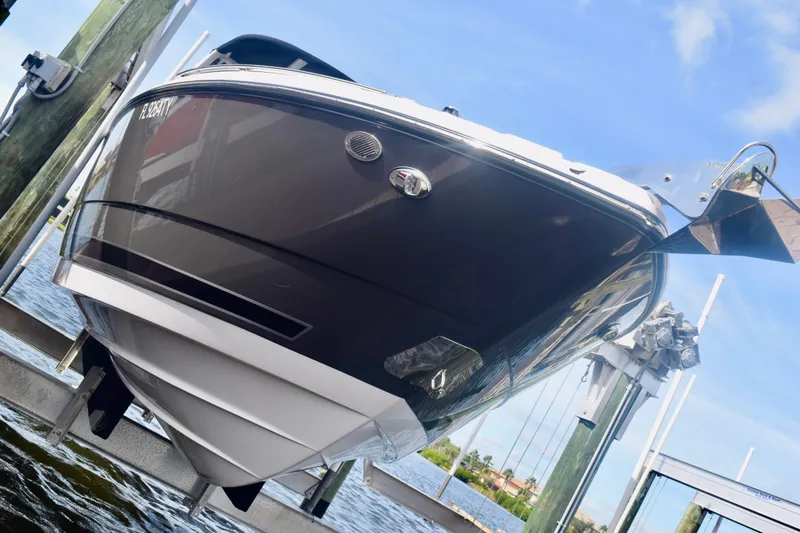  Yacht Photos Pics 2025 Monterey 275SS Super Sport boat on lift, docked by the water.