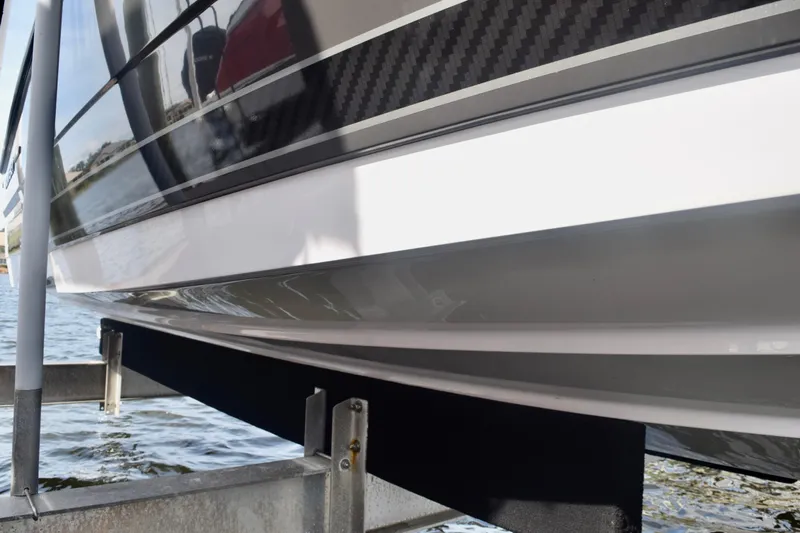  Yacht Photos Pics 2025 Monterey 275SS Super Sport boat hull on a lift by the water.