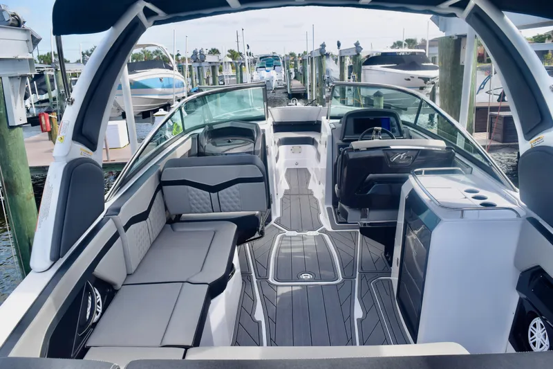  Yacht Photos Pics 2025 Monterey 275SS Super Sport boat interior with sleek seating and modern dashboard at a marina.