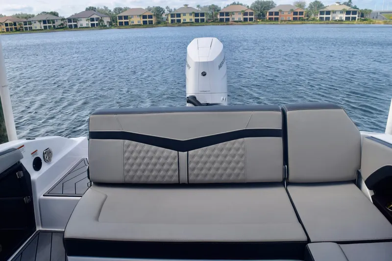  Yacht Photos Pics 2025 Monterey 275SS Super Sport boat interior with luxurious seating and scenic waterfront view.