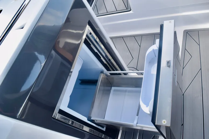  Yacht Photos Pics Open storage compartment on 2025 Monterey 275SS Super Sport boat, showcasing sleek design.