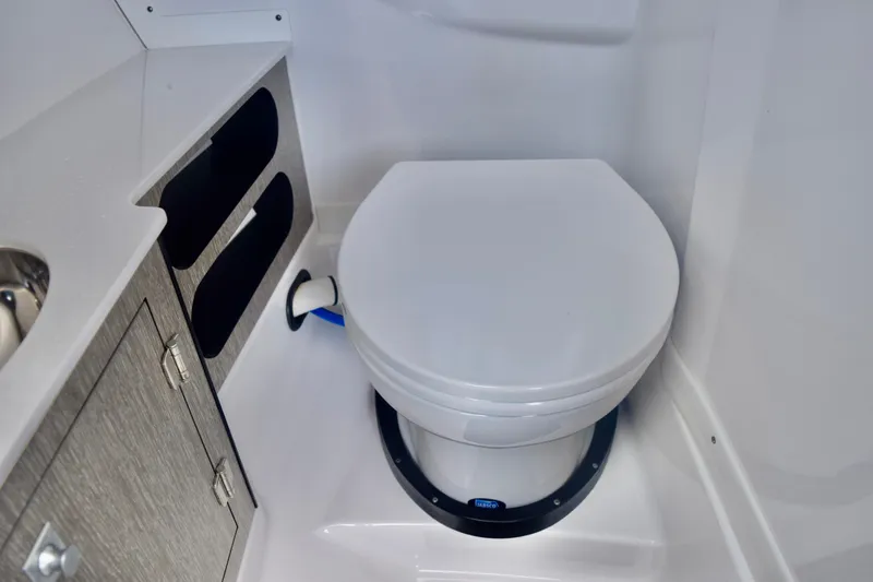  Yacht Photos Pics 2025 Monterey 275SS Super Sport boat bathroom with modern toilet and storage cabinets.