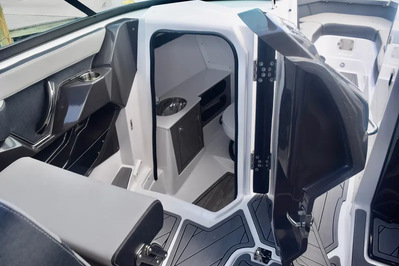  Yacht Photos Pics 2025 Monterey 275SS Super Sport boat interior with open cabin door and seating area.