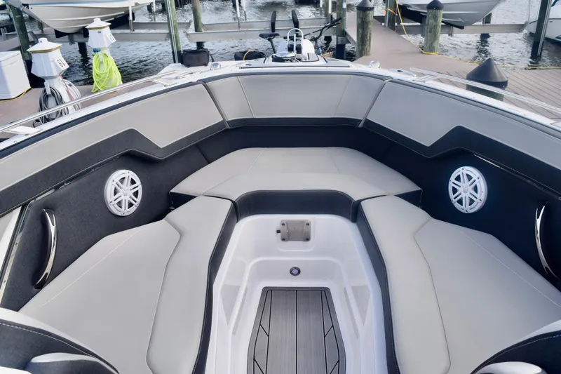  Yacht Photos Pics 2025 Monterey 275SS Super Sport boat interior with cushioned seating and speakers at a dock.