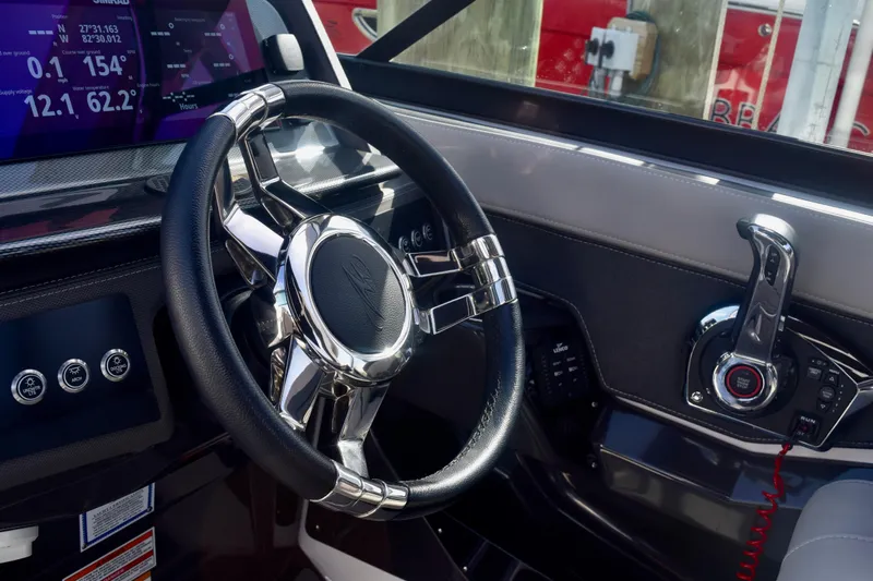  Yacht Photos Pics 2025 Monterey 275SS Super Sport boat dashboard with steering wheel and control panel.