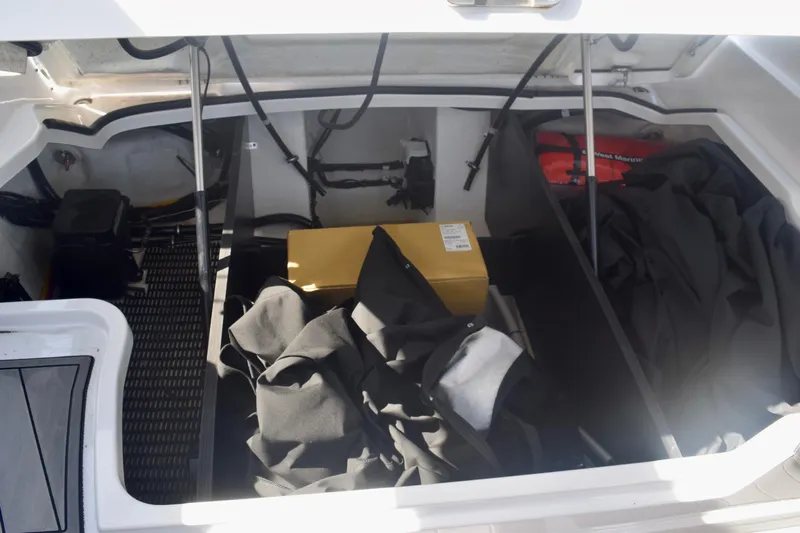  Yacht Photos Pics Storage compartment of 2025 Monterey 275SS Super Sport boat with various items inside.