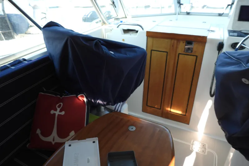 Yacht Photos Pics Interior of a 2005 Back Cove 29 boat with nautical decor and wooden cabinetry.