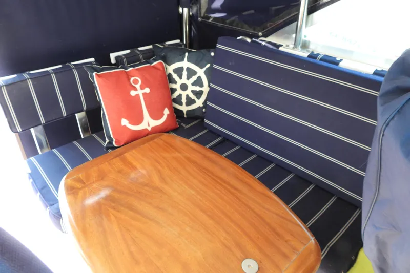  Yacht Photos Pics Nautical-themed seating area on a 2005 Back Cove 29 boat with anchor and wheel pillows.