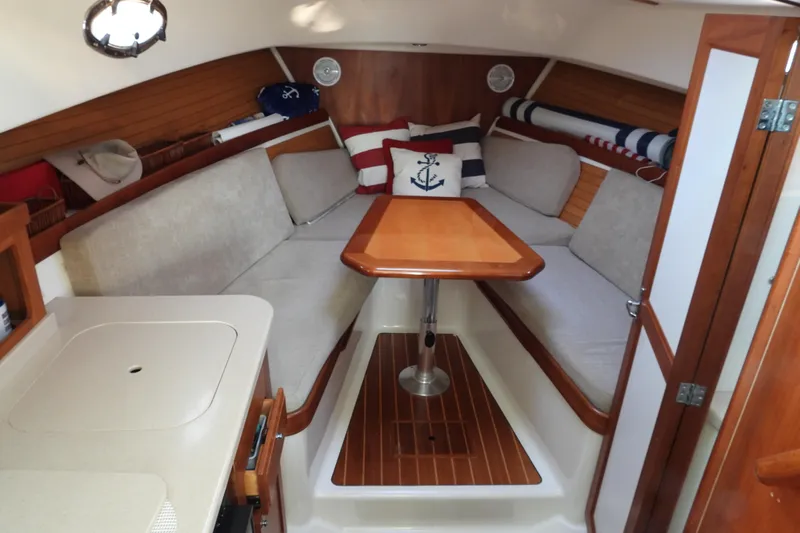  Yacht Photos Pics Cozy interior of 2005 Back Cove 29 boat with cushioned seating and wooden table.