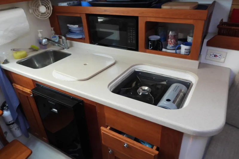  Yacht Photos Pics 2005 Back Cove 29 boat kitchen with sink, stove, and microwave.